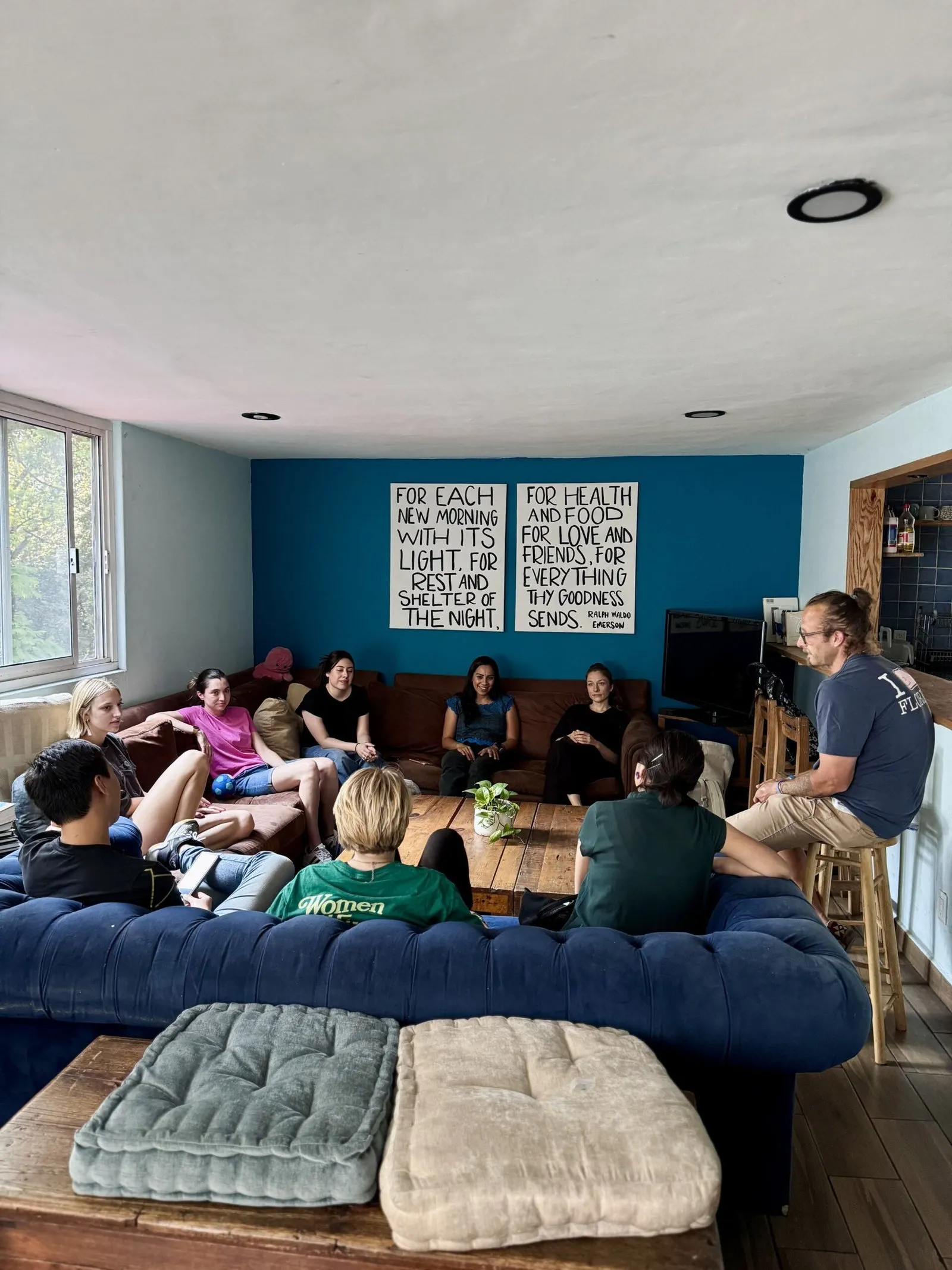 Students gathered in a living room for a teaching session